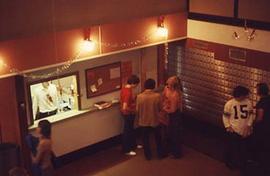 Student standing in front of mailboxes in Douglas Hall.