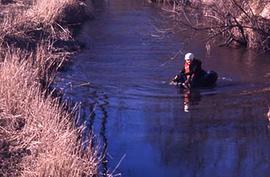 An individual rowing on inner tub down Salmon River on Trinity's campus