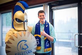 Scholarship winner Aaron Gruenhage with Spartans mascot