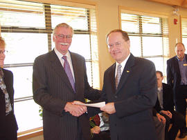 Sodexho President Garry Knox presenting a cheque to President Neil Snider