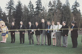 Staff and administrators participating in the ribbon-cutting for the new soccer field