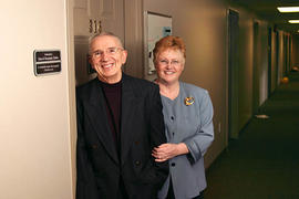 Stan and Rosemary Dobbs posing next to dormitory room 316