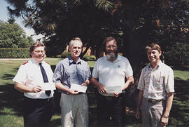 Bill Norris with three recipients of TWU Employee Charitable Fund presentations