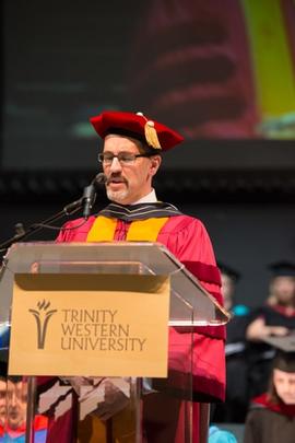 Calvin Dyck delivering the commencement address at Grad 2013