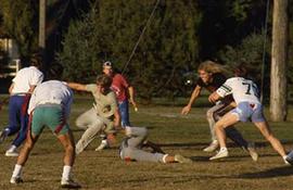 Students playing football on campus.