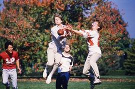 Students playing football on campus.