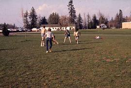 Students playing football on campus.