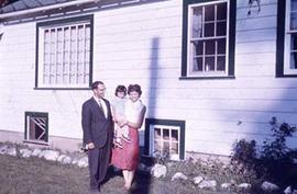 Faculty members Leland and Alice Asa with a child.