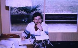 Unidentified individual seated in the dining hall.