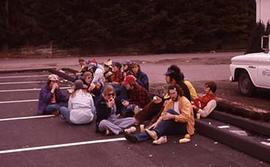 Students hanging out in a parking lot on campus.