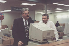 Librarian Rick Wiebe with administrator Ron Kuehl in the library