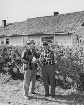 Robert Thompson with his father on the family farm.