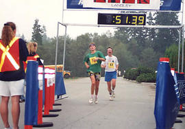 Two entrants crossing the finish line of the TWU 10K Fun Run