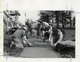 Students leveling cement during the Work-a-thon