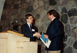 Terry Winter shaking hands with Dwight Johnson