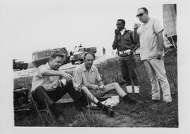 Robert Thompson with unidentified individuals eating lunch after the surrender during the Biafran...