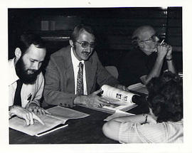 Faculty members helping at registration tables