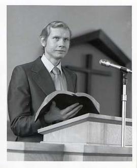 Staff member speaking from a pulpit