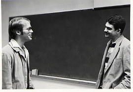 Craig Evans talking with a male student