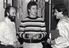 Alan Kotanen talking with two students