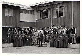 Concert choir posing outside Douglas Hall