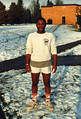 Honour Chikara in shorts standing outside on the campus grounds in the snow