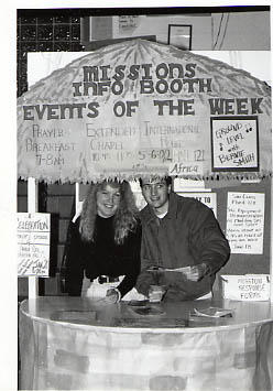 Two students in the Mission Week information booth