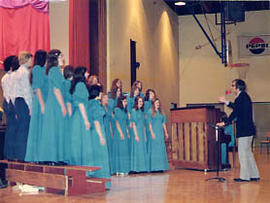 Concert choir performing in the gym