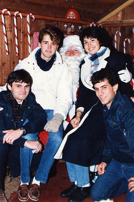 Instructor Dave Thomas and three students with Santa