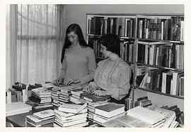 Staff members sorting books in the library