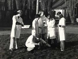 Mixed group of science students conducting experiments