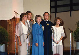 Dr. and Mrs. Snider singing with their children during Convocation