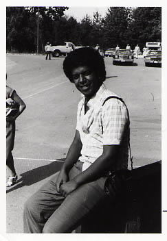 Aklilu Mulat sitting on a sign