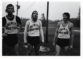 Three muddy male track team members