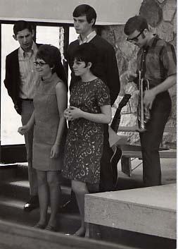 The Son Seekers standing on stage in the chapel