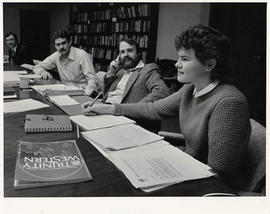 Ginny Westman at a conference table with faculty members