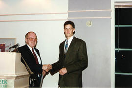 Ivan Pettigrew presenting an award to an aviation student