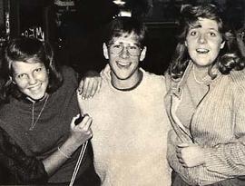 Three students posing together while smiling