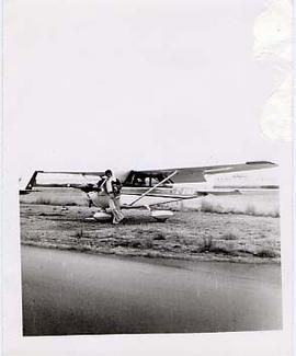 An aviation student leaning on a propeller