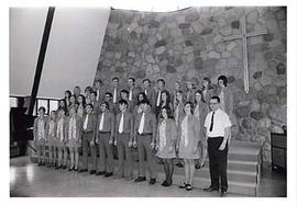 Choir standing on stage in the chapel