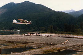 An airplane landing at 20 Mile Bay