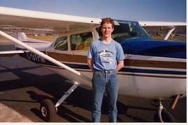 Glenn Brooks posing with an airplane