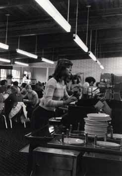 Female student eyeing the options in the cafeteria