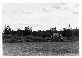 Tractor preparing a site for sewage