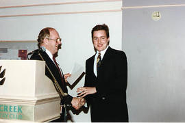 Ivan Pettigrew presenting an award to an aviation student