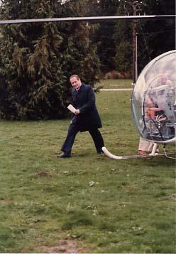 Dr. R. Neil Snider walking awy from a helicopter