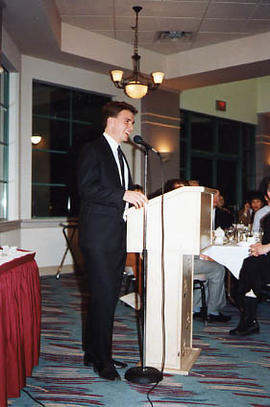 Greg Brown standing at a podium