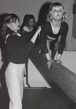 Student working with a girl on the beam