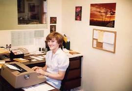 Library secretary typing at her desk