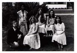 Music group, Aleithia, posing outside on a picnic table